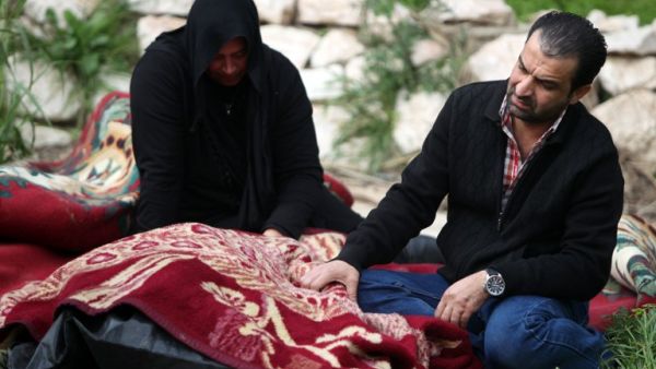 Iraqi's weep over the body of a relative killed on February 28, after the sinking of a floating restaurant belonging to the Lebanese Club in Baghdad. (AFP PHOTO/AHMAD AL-RUBAYE)