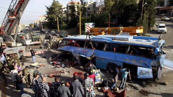 Lebanese security forces and civilians inspect the scene of a bus crash, killing and wounding several people, in the town of Kahaleh, ten kilometres east of Beirut on March 15, 2013, that was carrying Syrian refugees upon their arrival from Syria to Lebanon. (AFP PHOTO/ ANWAR AMRO)