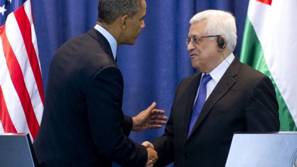 Palestinian president Mahmoud Abbas (R) and U.S. President Barack Obama shake hands following a joint press conference at the Muqata, the Palestinian Authority headquarters, in the West Bank city of Ramallah on Thursday. (AFP PHOTO/SAUL LOEB)