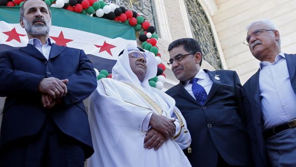 Moaz al-Khatib (L) with the Qatari delegation at the inauguration ceremony. (AFP PHOTO/KARIM SAHIB)