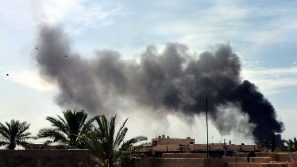Smoke rises from the site of a car bomb near the Imam Mahdi Islamic Center in Baghdad on March 29, 2013. A series of bombs near Shia mosques targeting worshippers attending weekly prayers killed at least 15 people, the latest in a spike in unrest ahead of Iraq's first polls since 2010. (AFP PHOTO / SABAH ARAR)