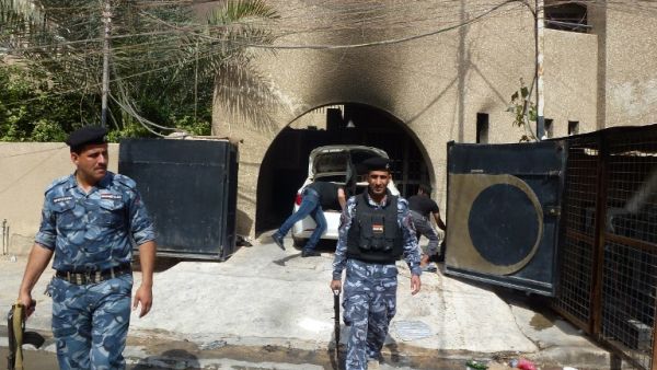 Iraqi policemen inspect the premisses of the al-Mustaqbal (The Future) newspaper in the Karrada district of Baghdad on April 2, 2013, following an attack. (AFP PHOTO/SABAH ARAR)