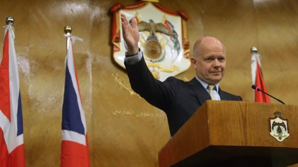 British Foreign Secretary William Hague waves during a press conference in Amman on May 22 (AFP)