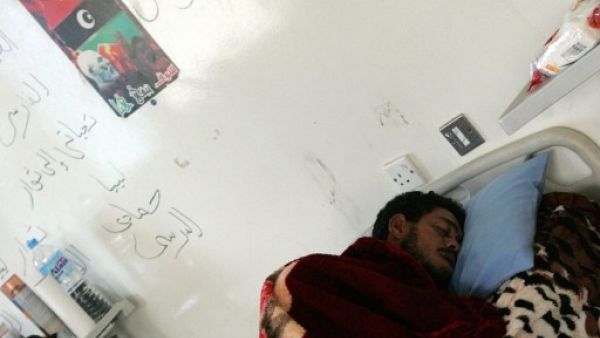 A Libyan soldier wounded from overnight clashes rests in his hospital bed on Saturday in Benghazi. AFP image