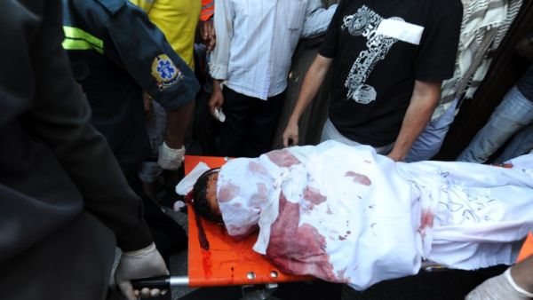 A slain Muslim Brotherhood protester is carried away in Cairo on July 27. AFP / FAYEZ NURELDINE