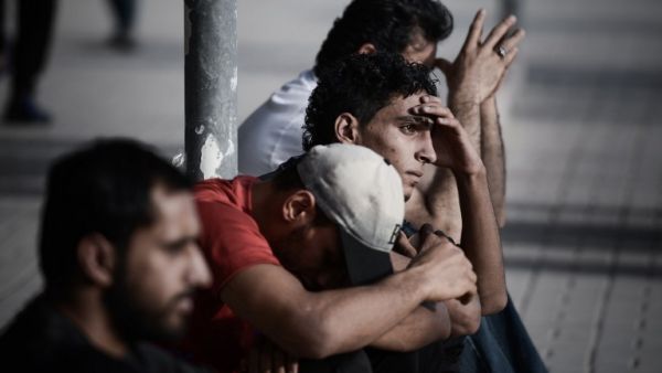 Bahraini men sit in the village of Sitra, south of Manama, on August 2, 2013. (AFP)