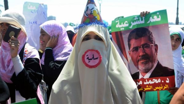 A supporter of Egypt's deposed president Mohamed Morsi, wearing a pin which reads in Arabic "Peaceful", attends a demonstration in the Mediterranean city of Alexandria on August 3, 2013. (AFP)