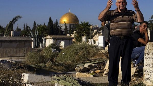 Palestinians visit the graves of loved ones at a Muslim cemetery near the Al-Aqsa Mosque compound as part of the Eid Al-Fitr holiday in the old city of Jerusalem on August 8, 2013. (AFP)