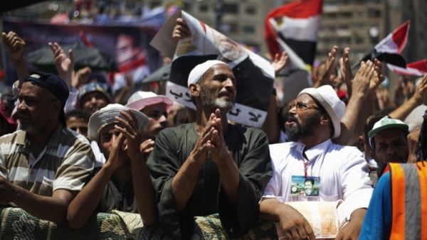 EGYPT, Cairo : Members of the Muslim brotherhood and supporters of ousted Egyptian President Mohammed Morsi attend a sit-in outside the Rabaa al-Adawiya mosque on the first day of Eid al-Fitr celebrations on August 8, 2013 in Cairo. (AFP)
