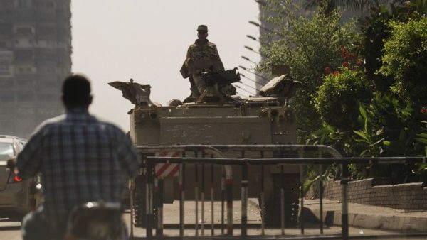 An Egyptian soldier keeps watch from the top of an army armoured personnel carrier at the entrance of Tahrir Square on August 18, 2013 in Cairo. (AFP)