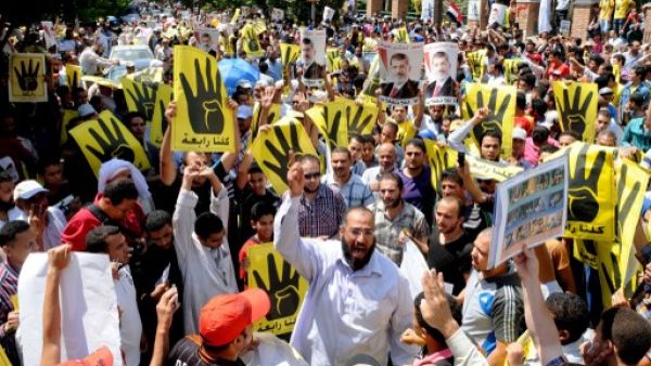 Supporters of the Muslim Brotherhood and Egypt's toppled president Mohamed Morsi (portrait) take part in a demonstration in Hilwan, south of Cairo, on August 30, 2013. (AFP)