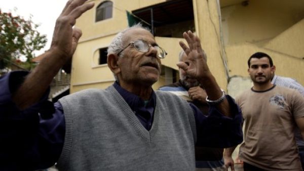 The family of Mohammed Adnan, a suspect in the bombing of the Iranian embassy in Beirut, have disavowed the alleged suicide bomber along with the Palestinian leadership. Here, his grandfather reacts in front of the building where his family lives (AFP)