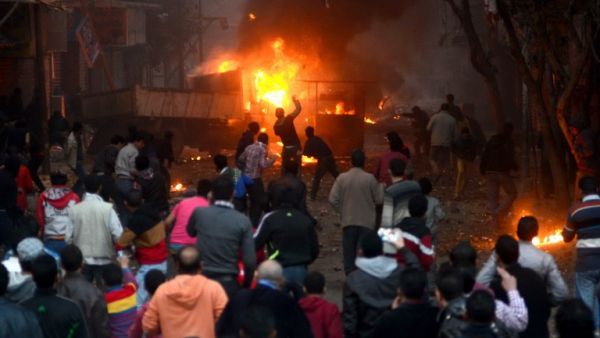 Supporters of the Muslim Brotherhood clash with civilians and Egyptian riot police in Alf Masskan district in the capital Cairo on January 17, 2014. [AFP]