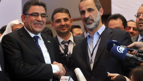 Syria's main opposition National Council chief Moaz al-Khatib (L) congratulates Syrian communications executive, Ghassan Hitto, after the National Council elected him as prime minister. (AFP PHOTO/OZAN KOSE)