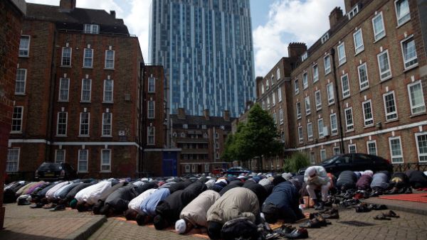 Muslims attend Friday prayers in the sunshine at the BBC Community Centre in the Spitalfields area, London, England (Getty)