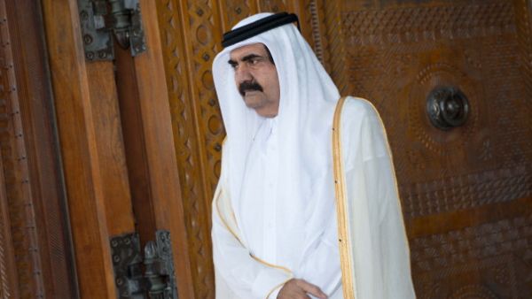 Qatari Emir Sheikh Hamad bin Khalifa al-Thani awaits for France's President Francois Hollande prior to a welcoming ceremony at the Diwan Emiri as part of a two-day official visit in Doha on June 23, 2013 (BERTRAND LANGLOIS/AFP/Getty Images)