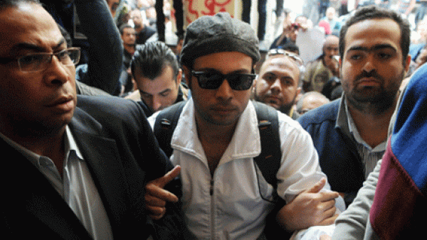Mohamed Adel is seen with Ahmed Maher , founder and former leader of the "April 6" movement, when Maher turned himself in at Abddein court in Cairo, November 30, 2013.