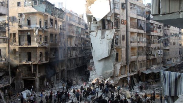 Syrians search for survivors amidst the rubble following an airstrike in the Shaar neighborhood of Aleppo on December 17, 2013. [AFP]