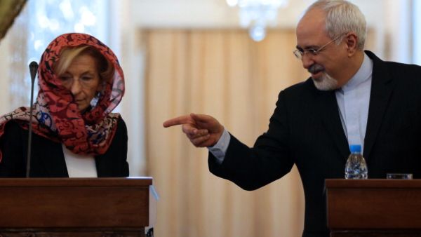 Iranian Foreign Minister Mohammad Javad Zarif  gestures towards his Italian counterpart Emma Bonino as they give a joint press conference in Tehran on December 22, 2013. [Getty Images]
