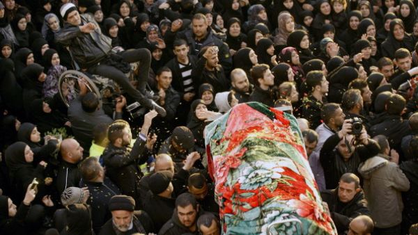 People carry one of the two bodies during the funeral of Malak Zahwa and her step-mother Iman Hijazi, who both died in a car bomb that targeted a Beirut's suburb the day before on January 3, 2014. [Getty Images]