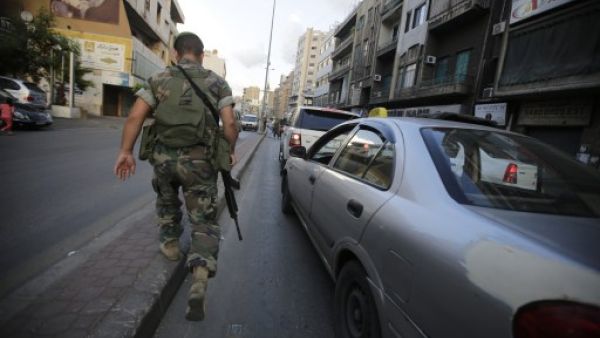 A Lebanese soldier walks towards a checkpoint in the southern suburb of the capital Beirut on September 23, 2013. (AFP)
