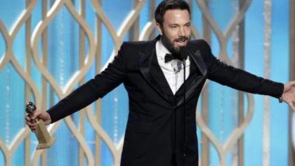 Ben Affleck picks up his Globe with pride.