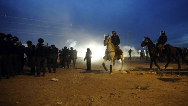 Mounted Israeli security stand guard as Bedouins protest against the Prawer plan in the southern village of Hura on November 30, 2013. (AFP) Mounted Israeli security stand guard as Bedouins protest against the Prawer plan in the southern village of Hura on November 30, 2013. (AFP)