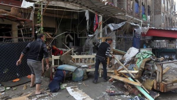Iraqi men clean the rubble at the site of a blast that took place the previous day outside a cafe in Baghdad's Bayaa neighborhood on November 21, 2013. One day after attacks killed 59 people across Iraq, a car bomb exploded in a busy market northeast of the capital. (AFP)