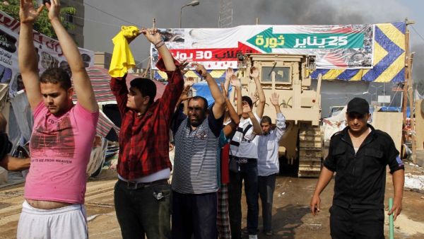 Egyptian security forces detain demonstrators after a crackdown on a protest camp by supporters of ousted president Mohamed Morsi and members of the Muslim Brotherhood on August 14, 2013 in Cairo's Rabaa al-Adawiya mosque. (AFP)