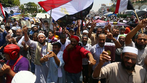  Supporters of Egypt's deposed president Mohamed Morsi chant islamic slogans during a rally outside Cairo's Rabaa al-Adawiya mosque on July 13, 2013. (Source: AFP/MARWAN NAAMANI)