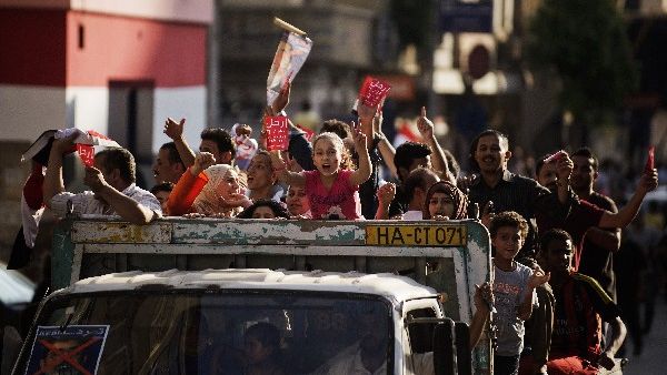 Egyptians shout slogans as they drive through the streets of Cairo on their way to join thousands protesting against President Mohamed Morsi and the Muslim Brotherhood at Tahrir Square on Sunday. (AFP)