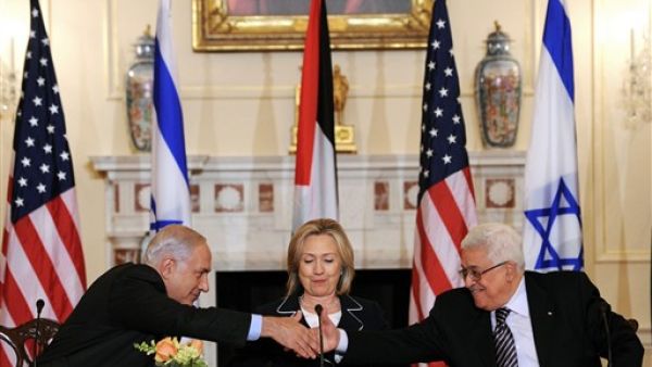 2010 US Secretary of State Hillary Clinton (C), looks on as Prime Minister Benjamin Netanyahu of Israel (L) and President Mahmoud Abbas of the Palestinian Authority (R) shakes hands as they re-launch of direct negotiations between Israeli and Palestinian Authority at the State Department in Washington, DC, on September 2, 2010