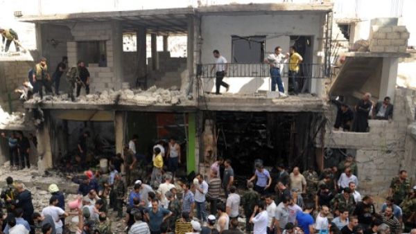 Civilians and security at the scene of a bombing in the Mezze 86 area of Damascus (AFP/SANA)