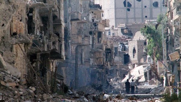Syrians walk down a destroyed street in the centre of Syria's northeastern city of Deir Ezzor on Thursday. The central city of Homs has been under a fierce aerial bombardment from regime forces, according to the Syrian Observatory for Human Rights. (AFP)