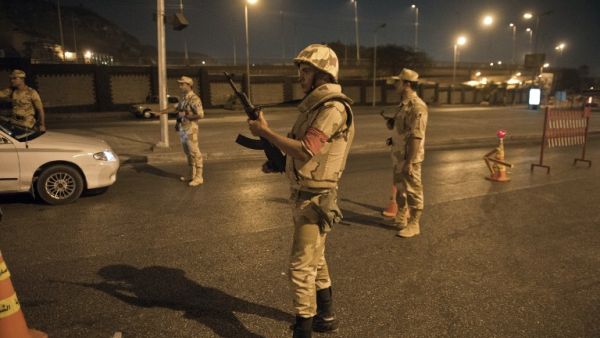  Egyptian troops keep watch at a checkpoint during the curfew hours in Cairo late on August 19, 2013