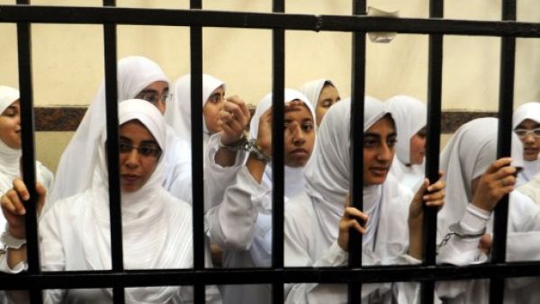 Female members of the Muslim Brotherhood are seen during their trial in the Egyptian city of Alexandria on November 27, 2013. Seven of the 21 arrested are aged between 15-17. (AFP)