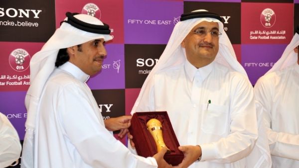 Mr. Khaled Al-Kuwari handing a miniature Emir's Cup to Mr. Bader as a token of QFA's appreciation