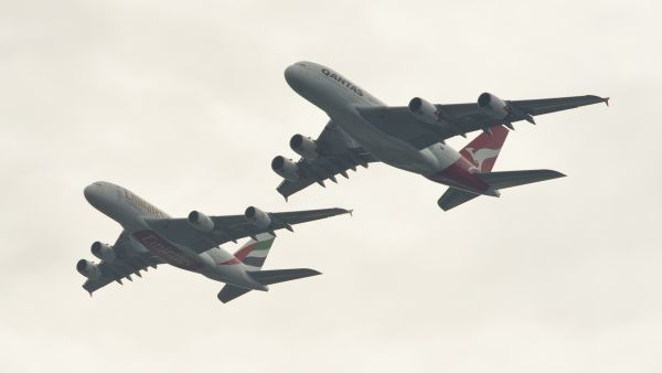 To celebrate the link-up, Emirates and Qantas staged a tandem flyover of the Sydney Harbour Bridge by two Airbus A380s. (JAMES MORGAN / QANTAS / AFP)