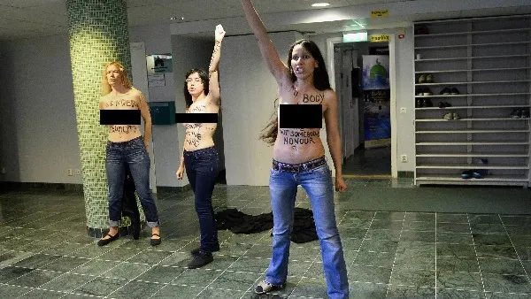 Egyptian activist Aliaa Elmahdy (C) and other members of feminist group FEMEN stage a topless protest  inside a Mosque in Stockholm, Sweden on Saturday (AFP)