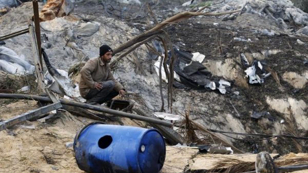 A Palestinian man inspects damage at a training site for the Al-Quds Brigades, the military wing of Islamic Jihad after on January 14, 2014 after it was hit by an Israeli air strike in Khan Younis in the southern Gaza Strip.