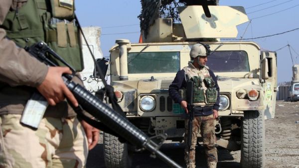 Iraqi soldiers monitor a checkpoint east of Baghdad on January 6, 2014. On Thursday, 13 Iraqi army recruits were killed by a suicide bomber in the capital city. (AFP)