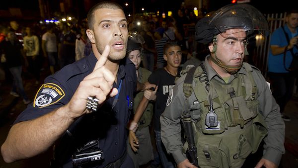 Israeli security forces arrest a Palestinian protestor in Jerusalem during a demonstration against the Israeli government's plans to relocate Bedouins in the Negev desert. (Source: AFP/AHMAD GHARABLI)