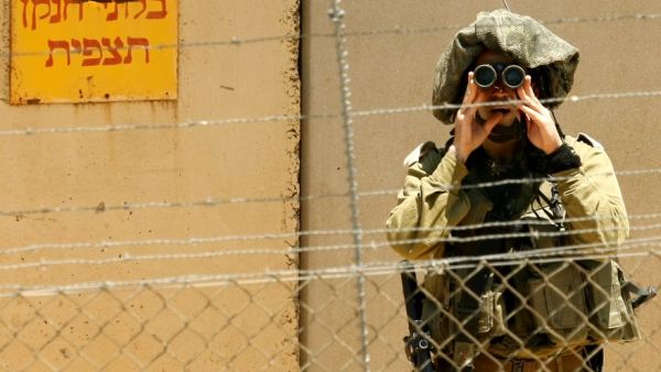 An Israeli soldier looks into Lebanon. The army has vowed to strongly respond to any Israeli aggression. (AFP/File)