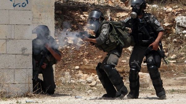 Israeli security forces fire tear gas during clashes with Palestinian protesters following a protest against the expropriation of Palestinian land by Israel. AFP Photo