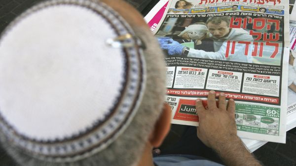 A Jewish faithful reads his daily paper. Shown strictly for illustrative purposes.