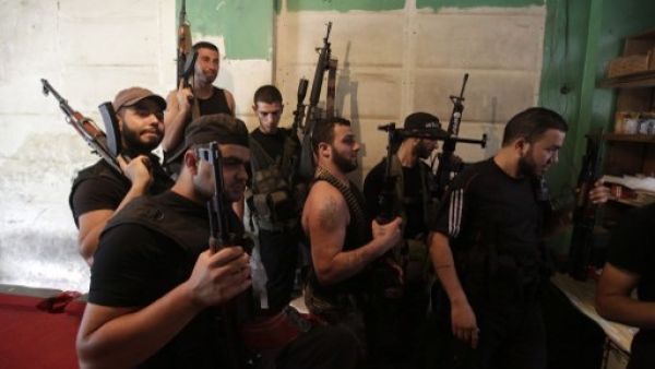 Lebanese Sunni militia men hold a meeting in the Sunni district of Bab Al Tabbaneh in Lebanon. AFP Photo