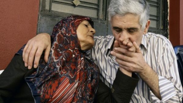 Abbas Hammoud, one of the nine Lebanese pilgrims held hostage in Syria for 17 months, is welcomed by his mother Mayla Aldurr upon his arrival at his home in the coastal city of Tyre in south Lebanon on October 20, 2013. On Wednesday, an activist announced that the Syrian authorities had released 14 women detained in the country as part of a hostage exchange deal. (AFP)