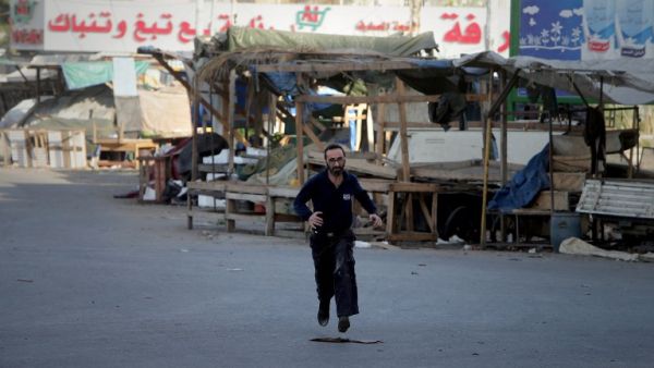A Lebanese man runs in the street at the entrance of Tripoli's Bab al-Tabbaneh Sunni area during clashes with the Alawite, pro-Syrian President Bashar al-Assad, Jabal Mohsen neighbourhood in the northern Lebanese city on December 2, 2013. The clashes have wounded at least 61 people, among them 12 members of the Lebanese army, which is deployed in the city and is responding to the sources of fire, the security source said. (AFP)
