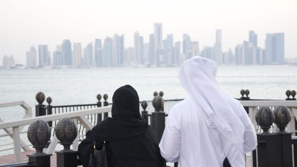 A man and woman look out at the Doha Skyline (Albawaba/J. Zach Hollo)