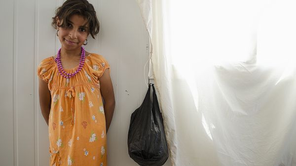 Maryam, a refugee from Syria, smiles as her family talks with reporters in 2013 at Jordan's Zaatari refugee camp (Albawaba File Photo/J. Zach Hollo). 